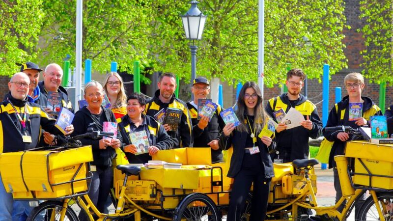 Aktion in der Innenstadt: Post-Zusteller verschenken 250 Bücher zum Welttag des Buches in Rheinberg